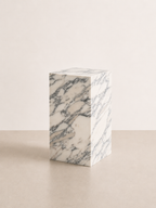 Luxury white marble with grey veining pattern rectangular block on a off white studio background. Front view.