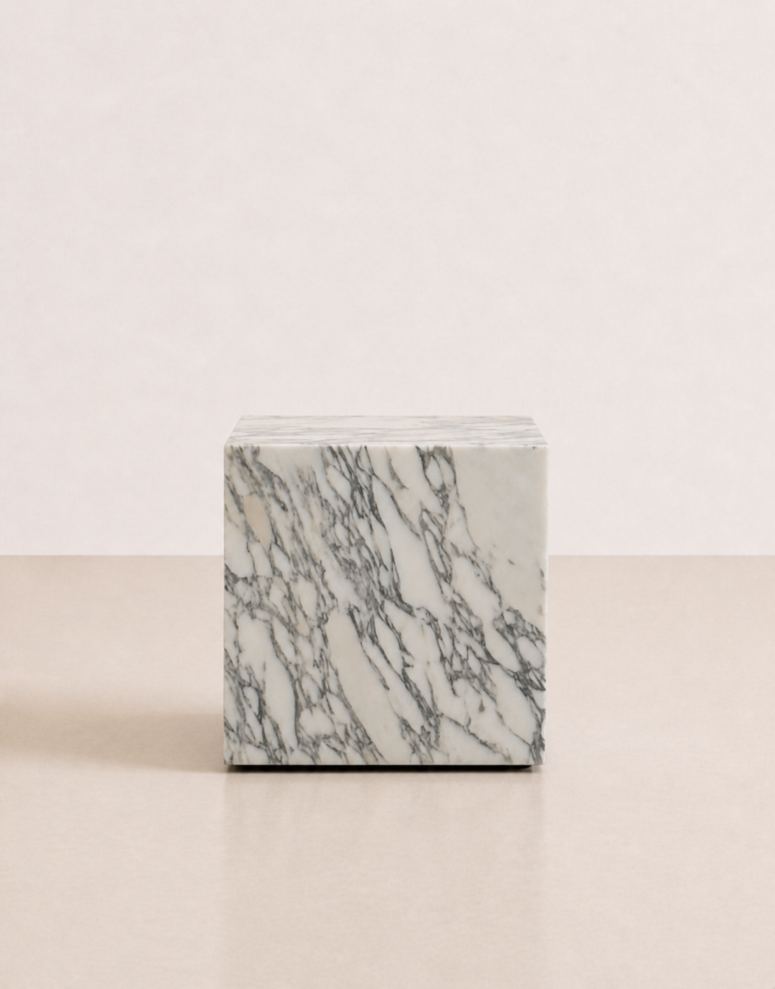 Luxury white marble cube with grey veining pattern rectangular block on a off white studio background. Front view.