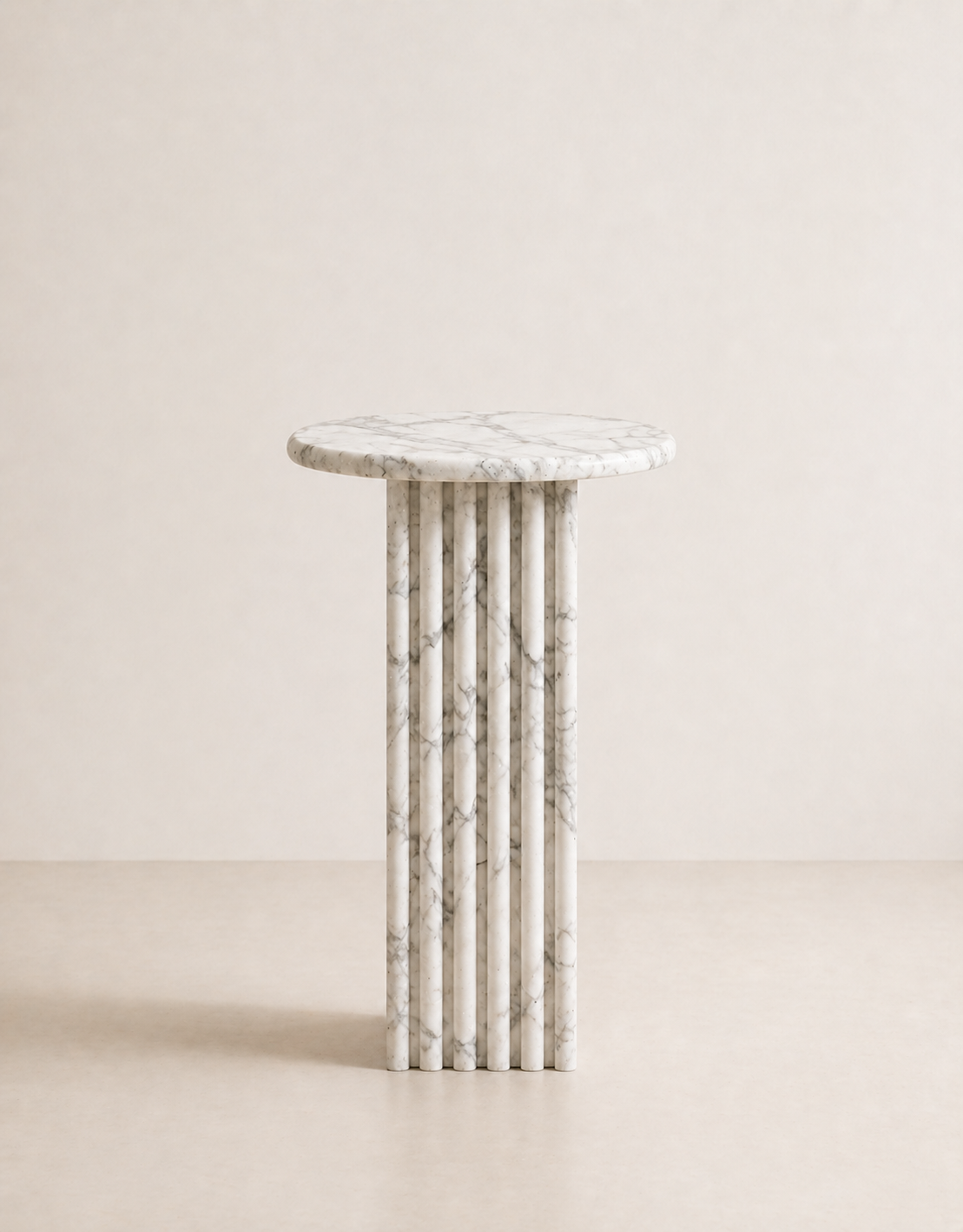 White marble side table with a ribbed cylindrical design n a beige background