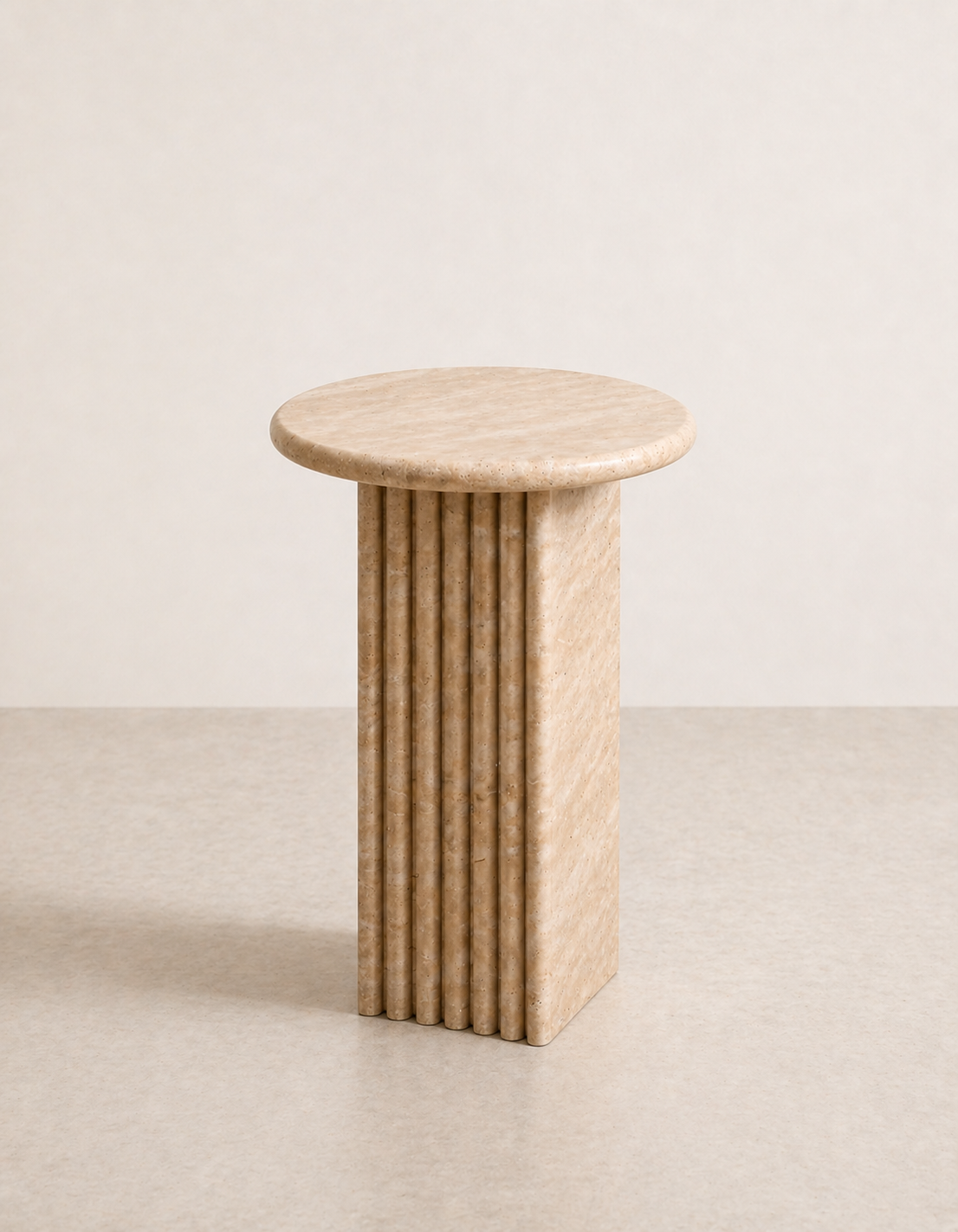 Beige travertine side table with a ribbed cylindrical design n a beige background