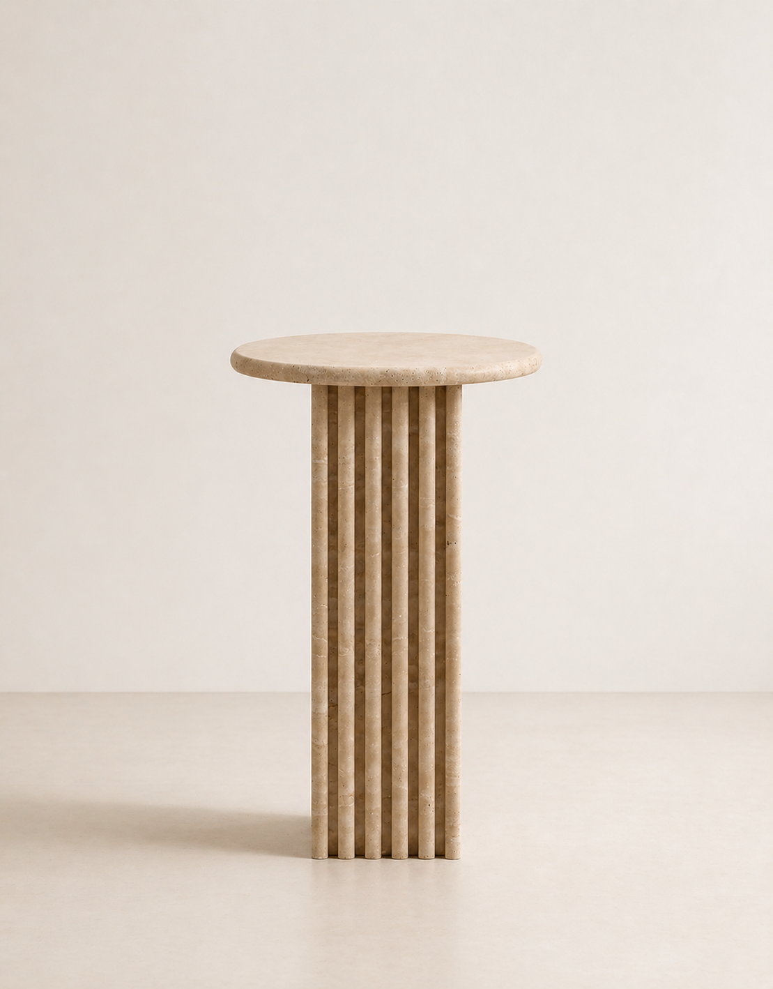 Beige travertine side table with a ribbed cylindrical design n a beige background