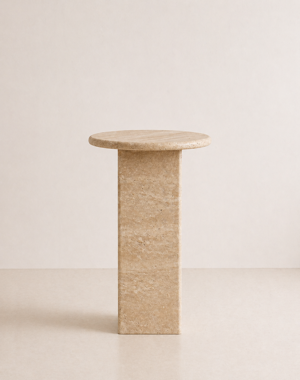 Beige travertine side table with a ribbed cylindrical design n a beige background
