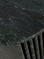 Close up of emerald green marble side table with a ribbed cylindrical design. Honed finish.