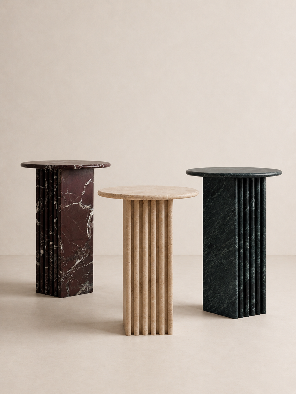 Three marble side tables with different colour patterns on a beige background
