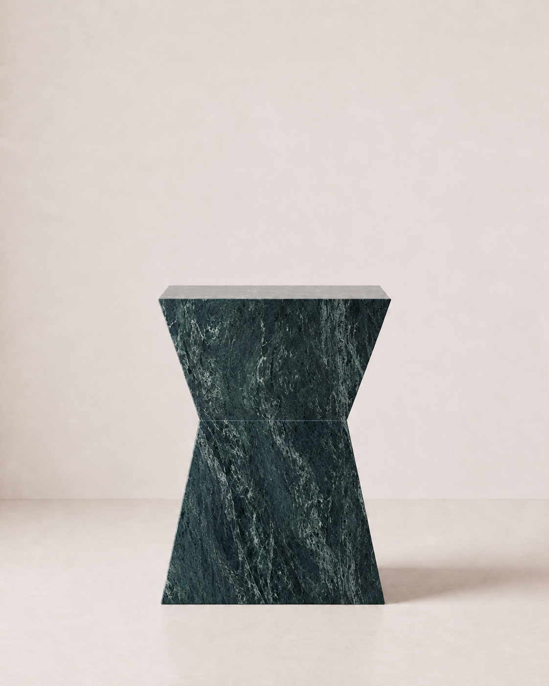 Hourglass shaped marble side table, made of luxury emerald green marble with delicate white veining, placed in a light beige studio. Front view.