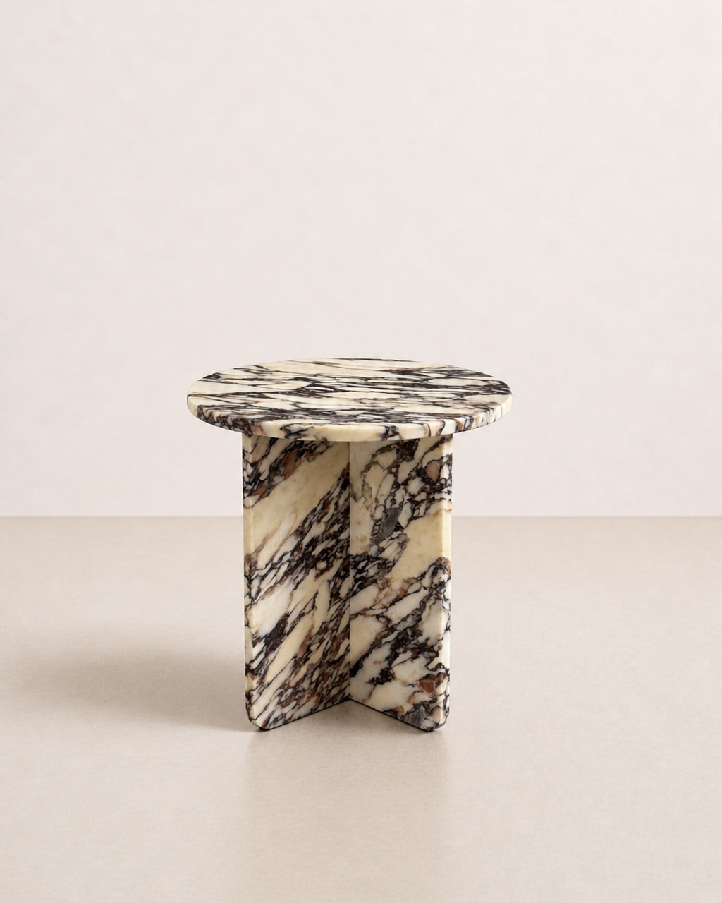 A luxury cream marble with delicate deep violet veining pattern round side table in a off white studio background. Side view.