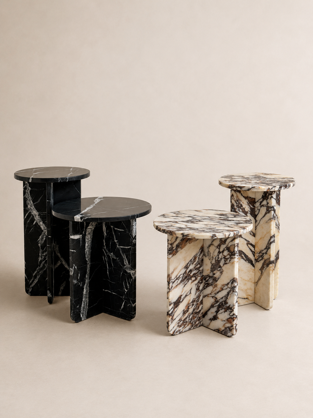 Editorial of two sets of luxury marble round side tables in a off white studio background. 