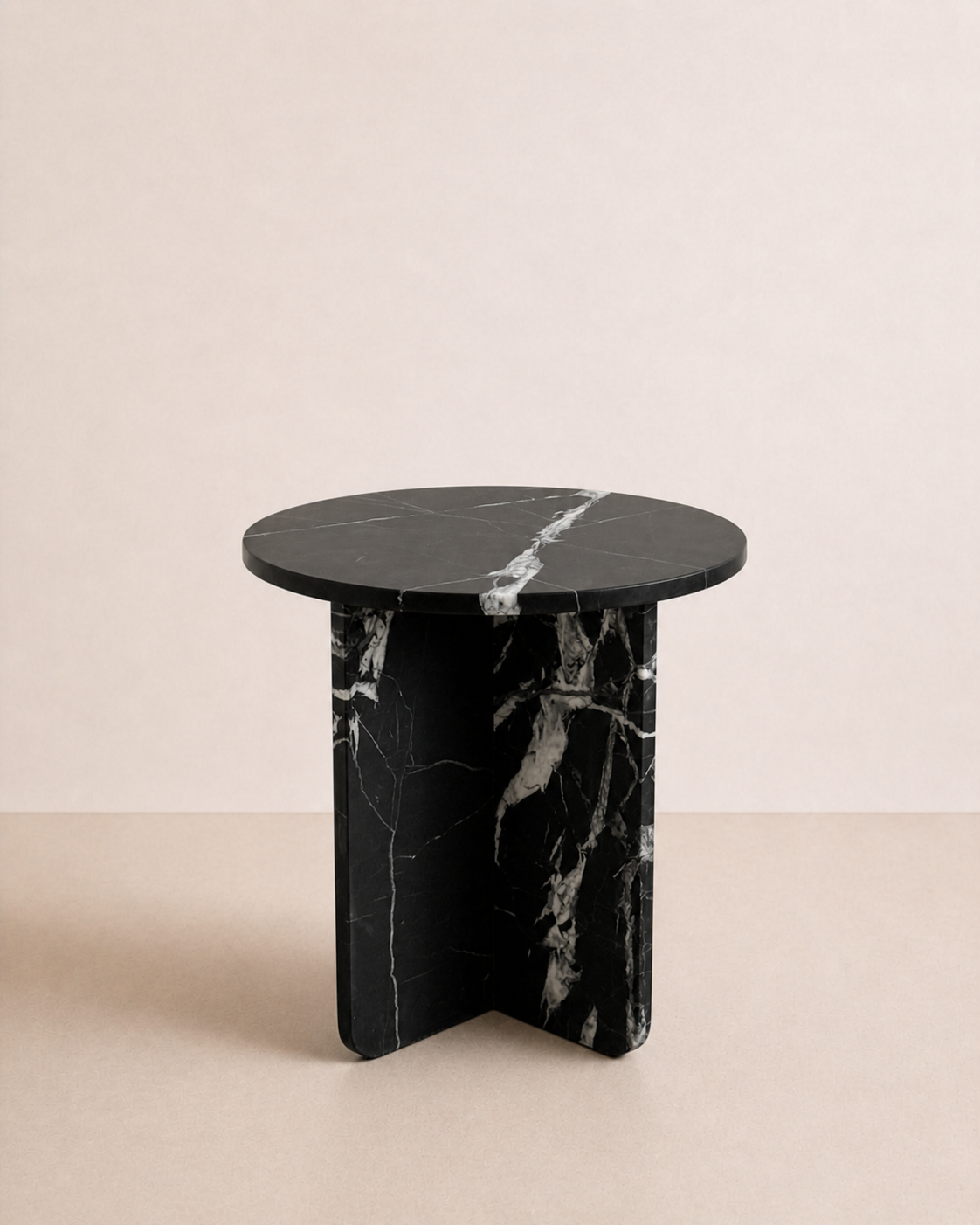 A luxury black marble with delicate white veining pattern round side table in a off white studio background. Side view.